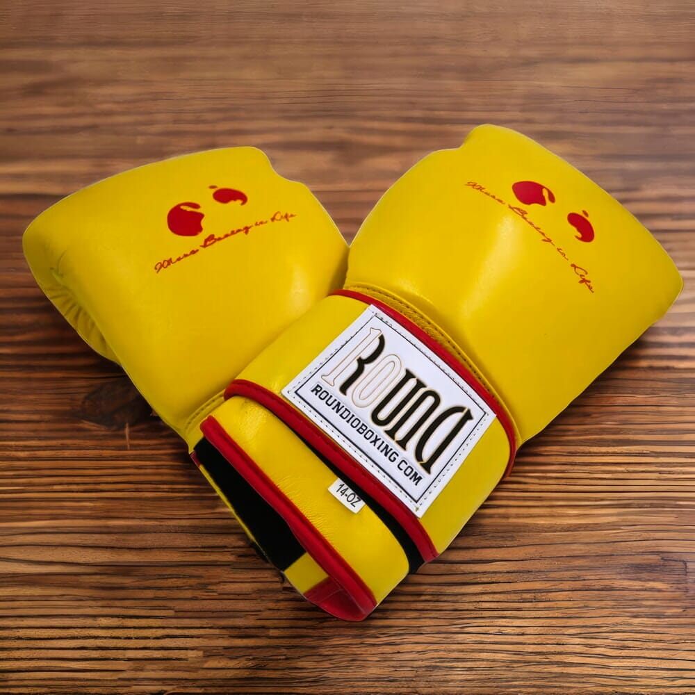 A pair of 12 oz black boxing gloves on a wooden table.