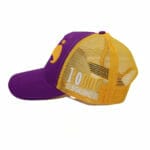 A purple and yellow trucker hat with a logo, inspired by Round 10 Boxing Caps.