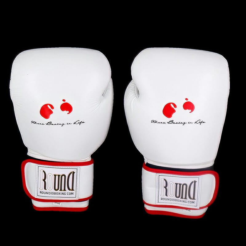 Two 12 oz white training gloves on a black background.