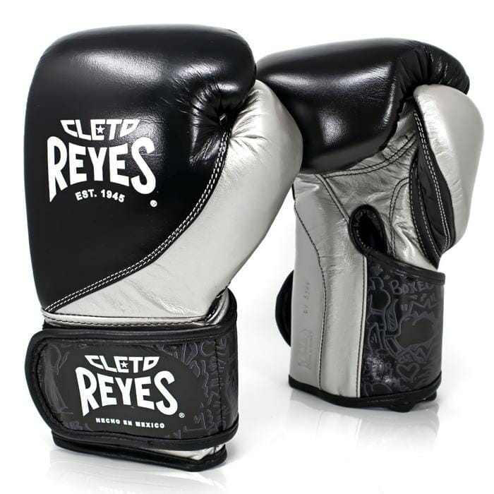 High Precision Training Glove Velcro - Black/Silver featuring a pair of 12 oz boxing gloves with the name Clef Reeves.